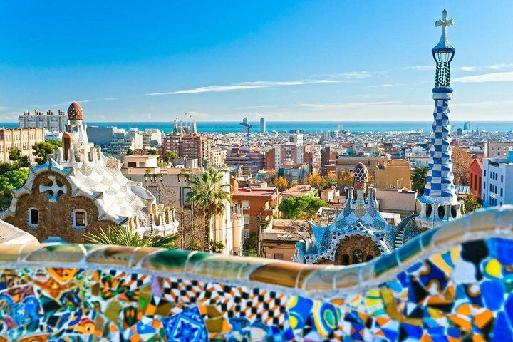 Is Viator Legit? What to Know Before You Book (2026) 10 Park Guell mosaic bench overlooking the Barcelona skyline and the sea