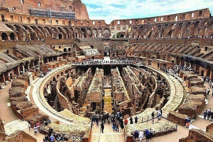 View from the upper tier of the Colosseum in Rome looking down on the arena floor platform and the exposed underground hypogeum
