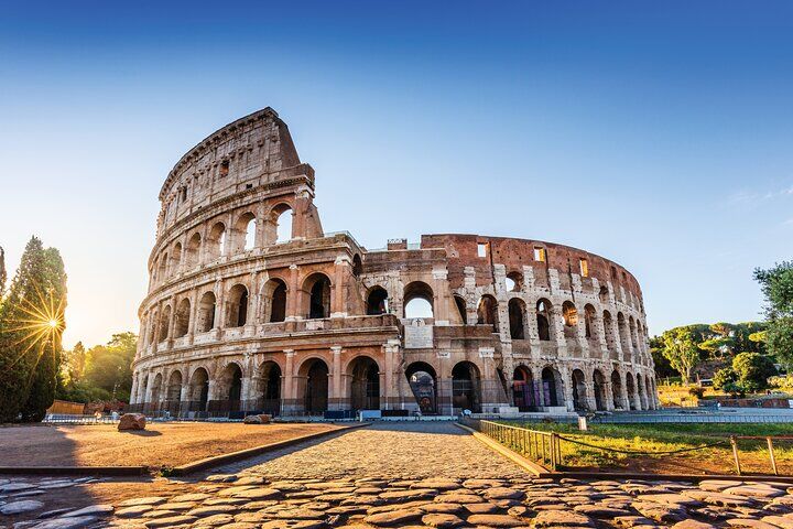 Viator vs GetYourGuide (2026): Which Is Better for Booking Tours? 10 Exterior of the Colosseum in Rome at sunset with the cobbled square in front